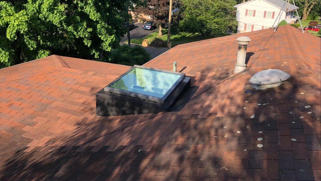 There is a skylight on the roof of a house.