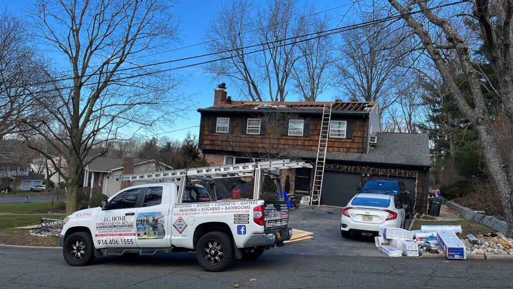 A truck is parked in front of a house that is being remodeled.