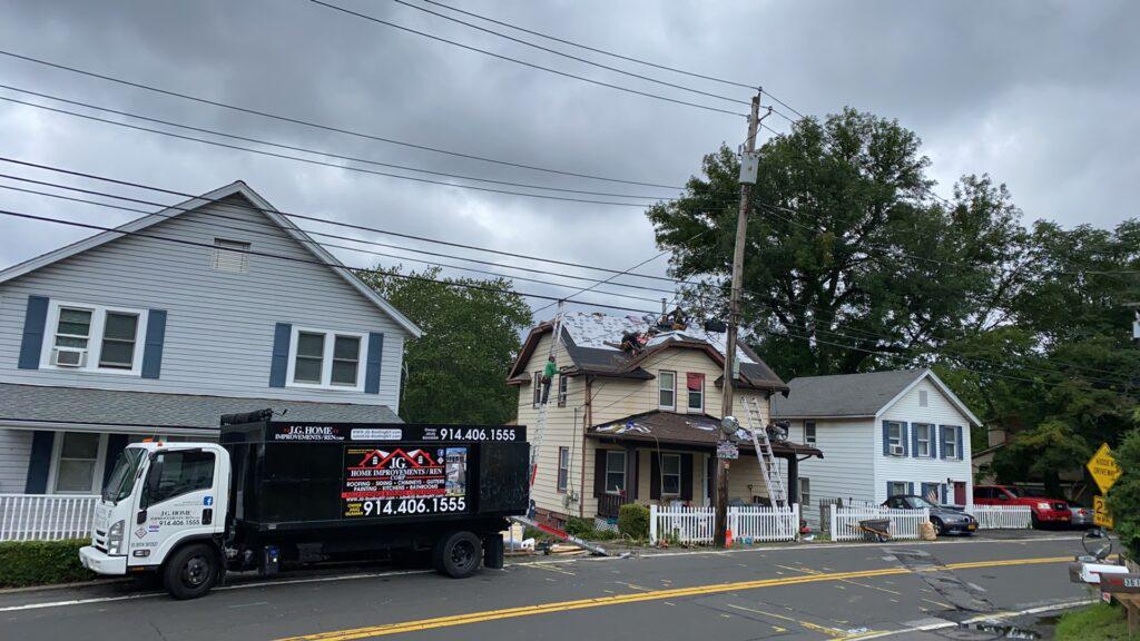 A garbage truck is parked in front of a house