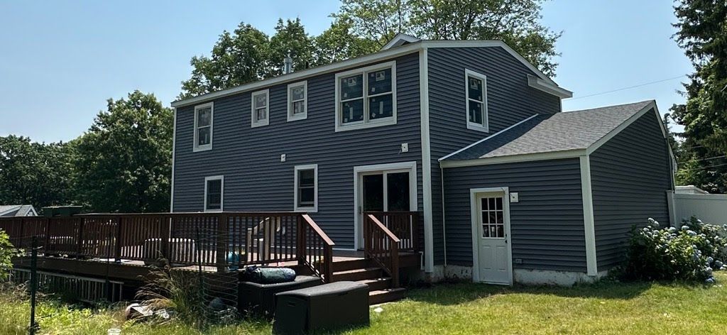 A large house with a large deck in the backyard