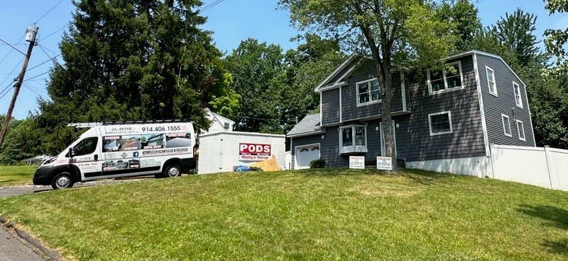 A white van is parked in front of a house.