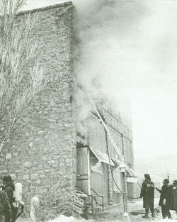 A black and white photo of a fire in a building.