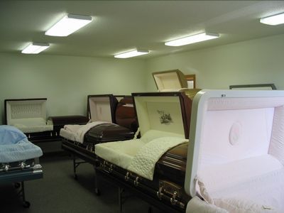 A row of coffins are lined up in a room