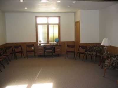 A room with chairs and a desk with a globe on it