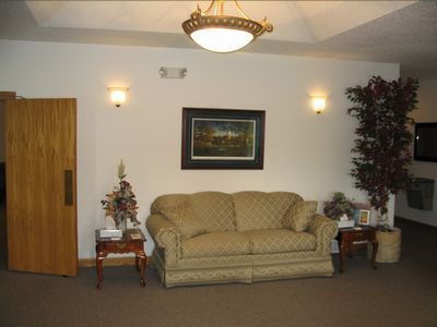 A living room with a couch and a picture on the wall