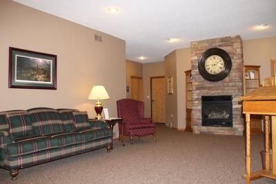 A living room with a couch a chair and a fireplace