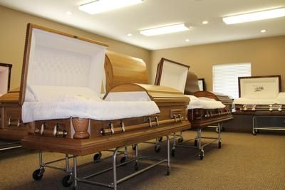 There are many different types of coffins in this room.