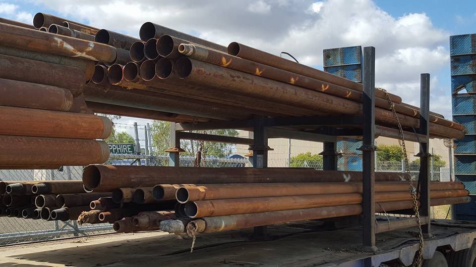 A Bunch Of Metal Pipes Are Stacked On The truck