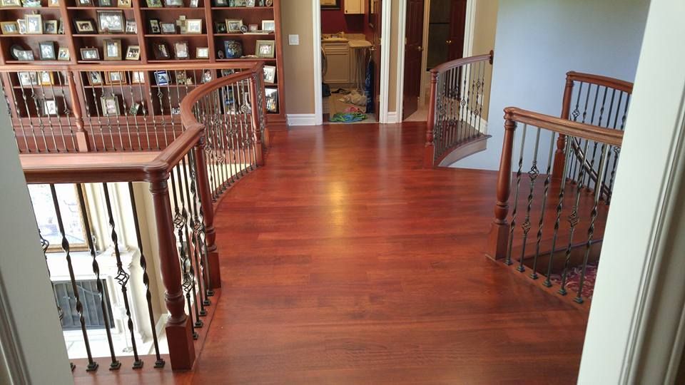 Stone fireplace with a white shelf, under construction in a room with tan walls and concrete flooring.