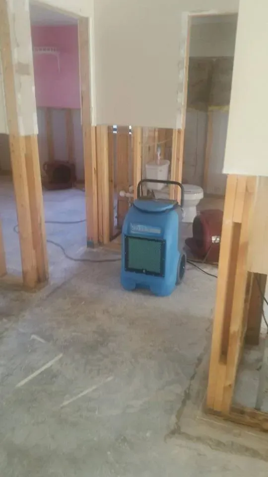 Blue cleaning equipment with a toilet behind it — Ashford, AL — Environmental & Hazmat Services Inc.
