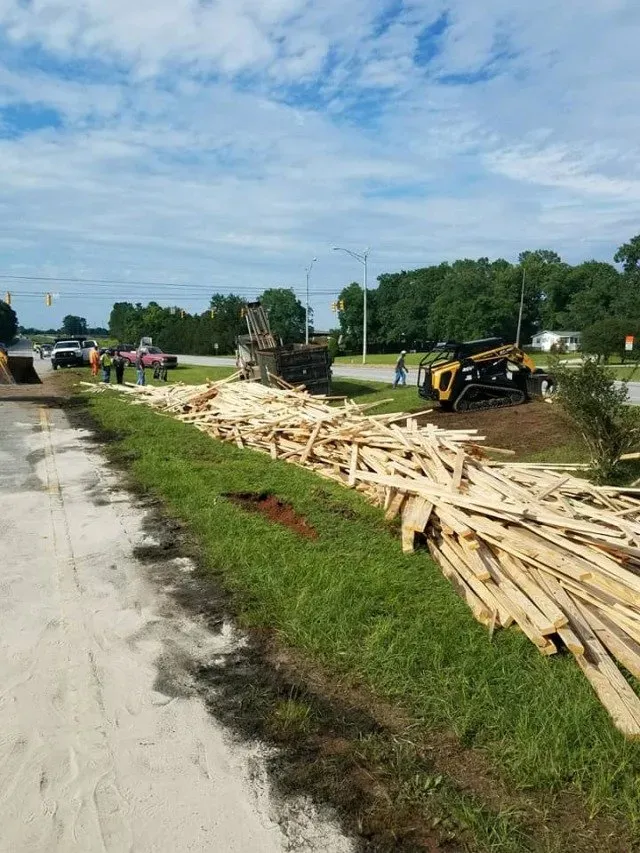 A road with a pile of wood on the side — Ashford, AL — Environmental & Hazmat Services Inc.