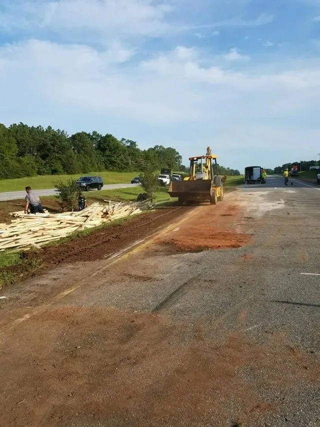 A tractor parked on the road with a pile of wood — Ashford, AL — Environmental & Hazmat Services Inc.
