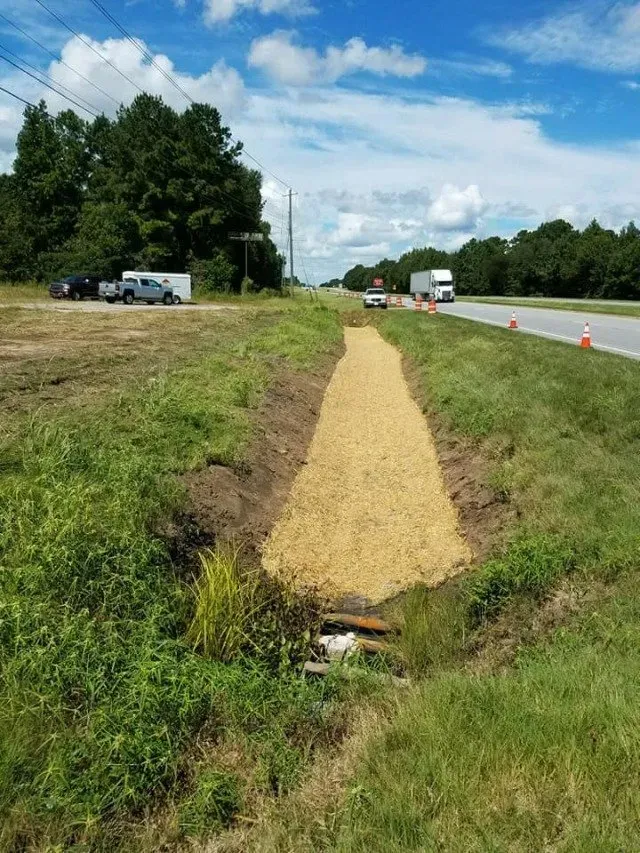 A pit alongside the road covered by hay — Ashford, AL — Environmental & Hazmat Services Inc.