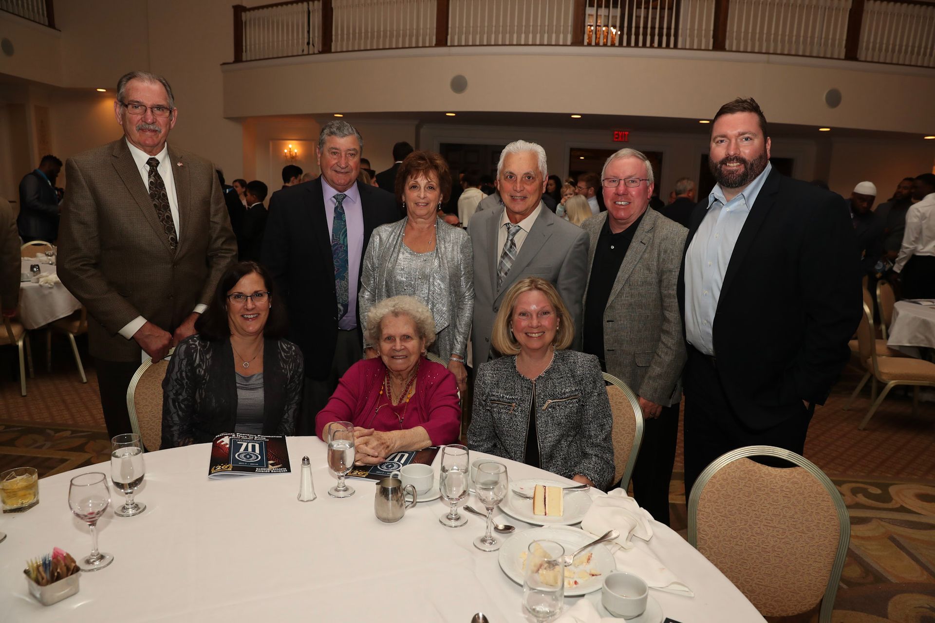 a group of people posing for a picture at a table