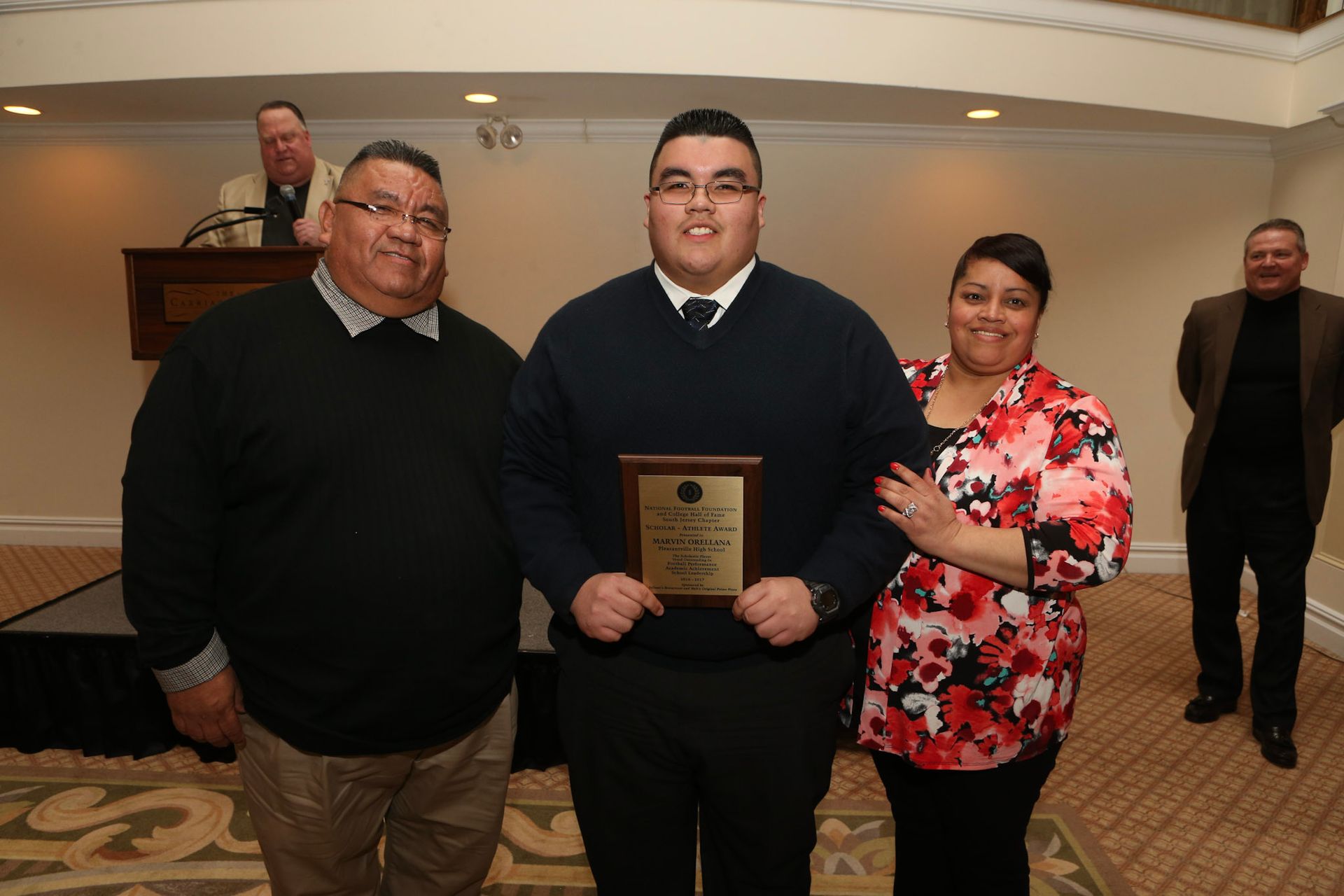 a man holding a plaque that says ' winner ' on it
