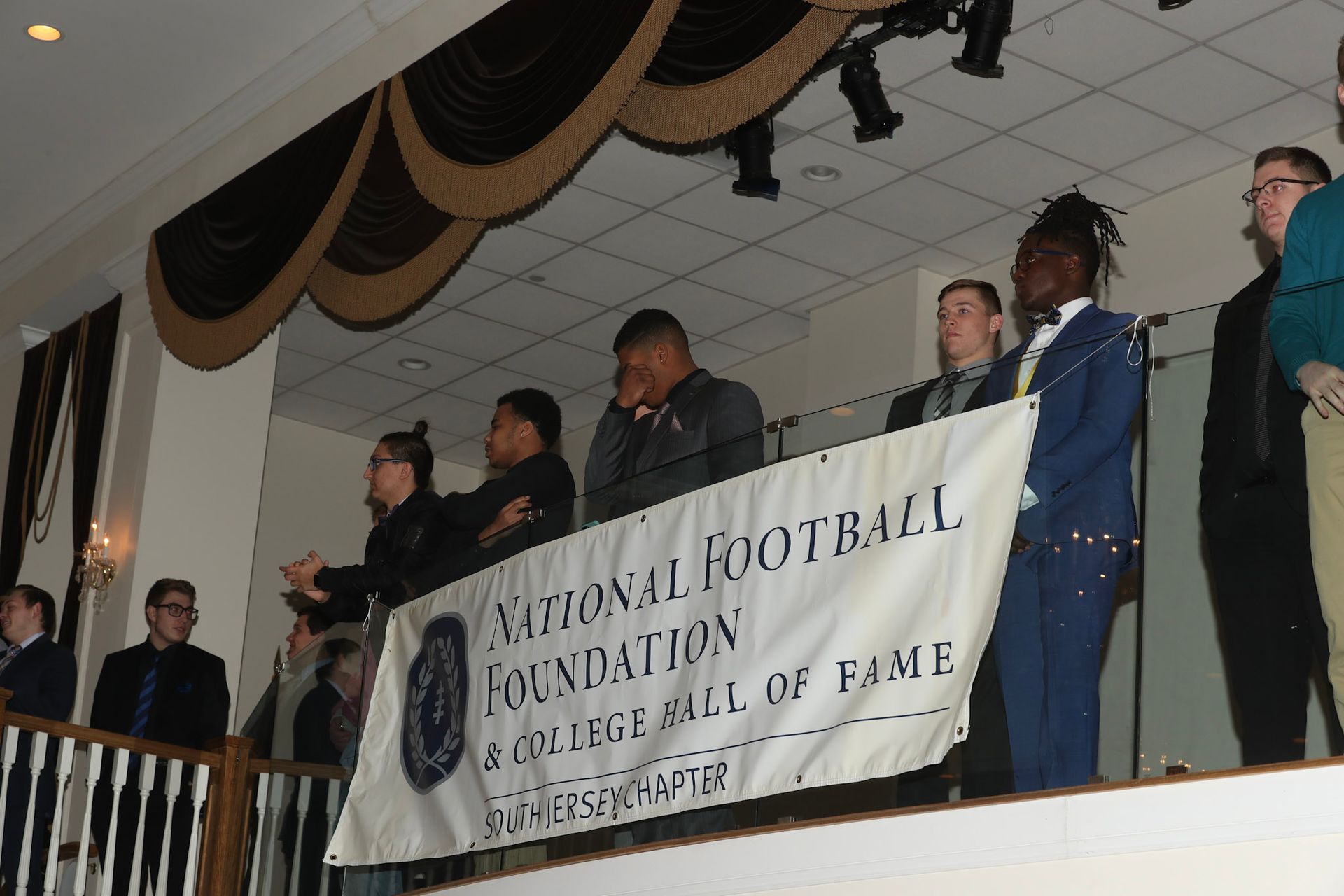 a group of people standing behind a banner that says ' foundation ' on it