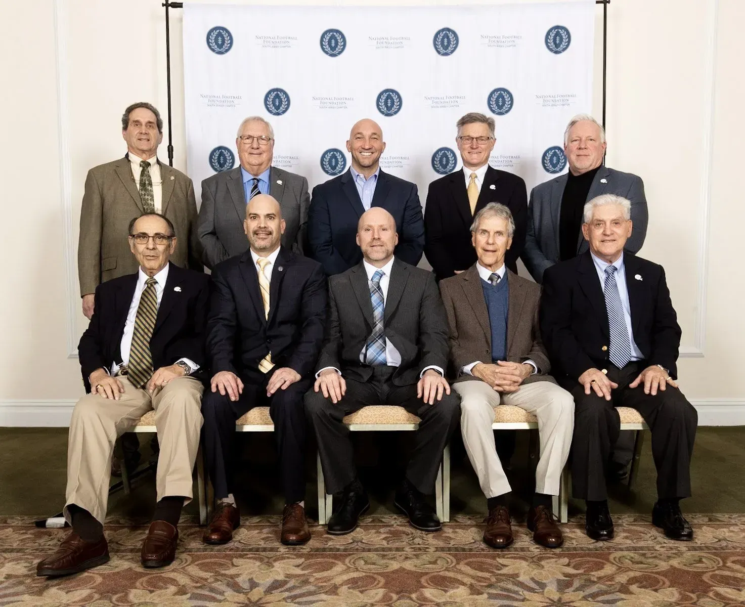 a group of men in suits and ties pose for a picture