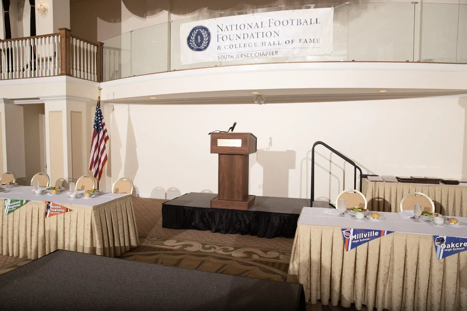 a podium in a room with tables and chairs