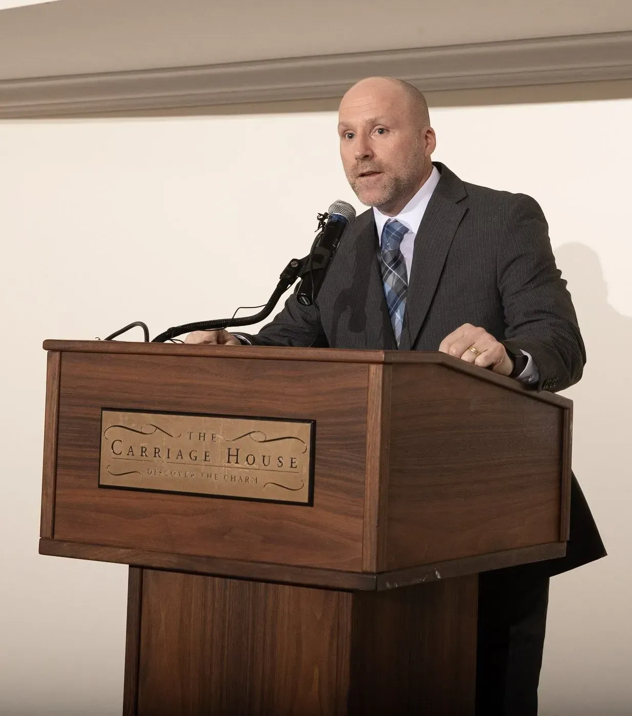 a man stands at a podium that says capitol house