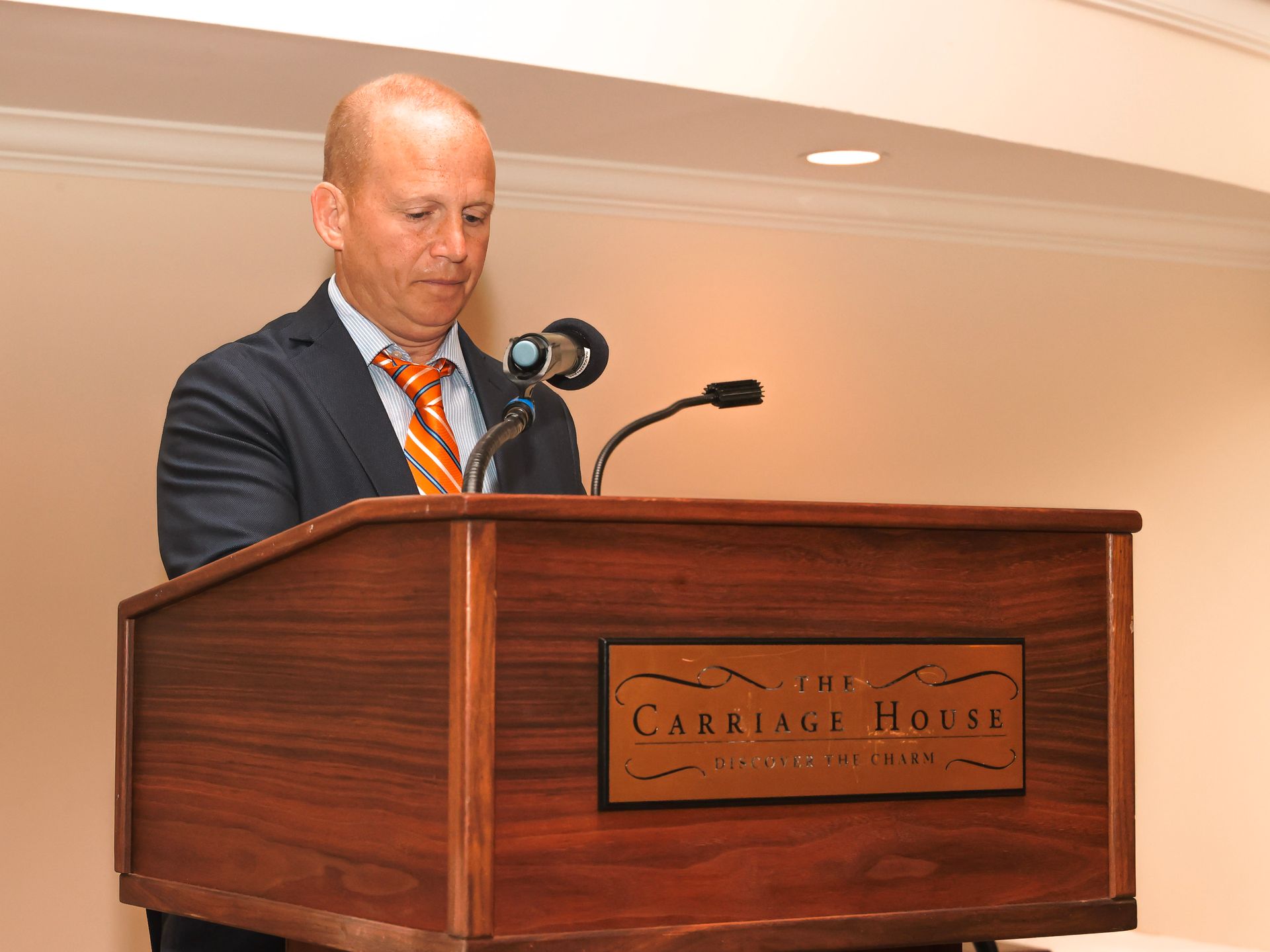 a man stands at a podium that says the cark and house