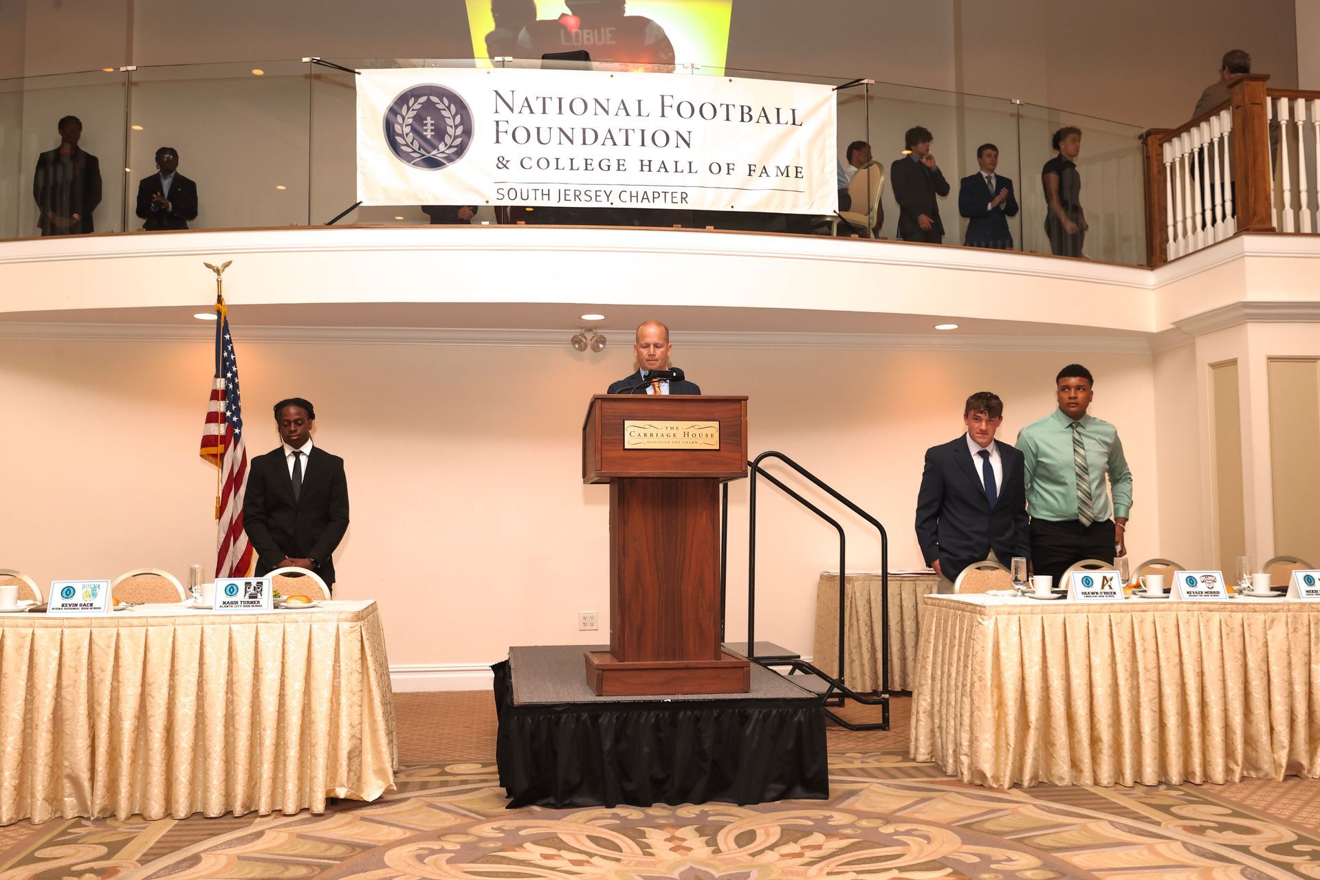 a man stands at a podium in front of a sign that says ' foundation '