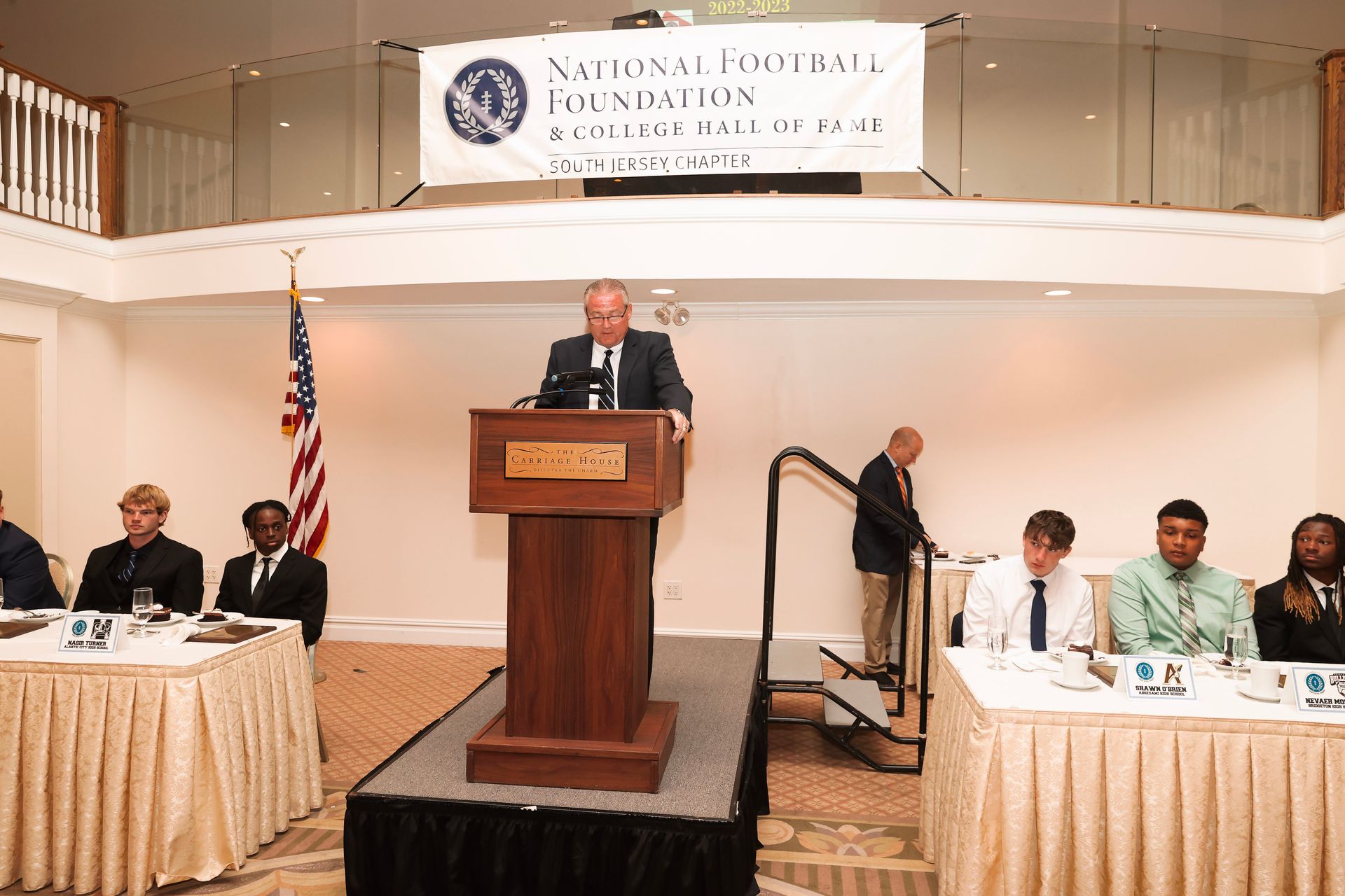 a man stands at a podium in front of a sign that says national central