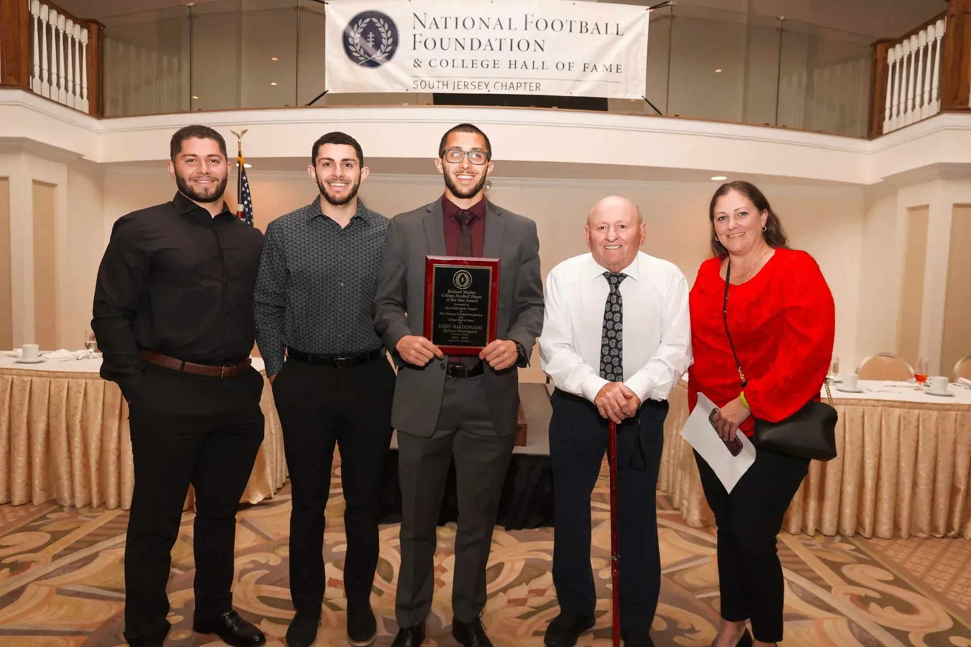a group of people standing in front of a sign that says national