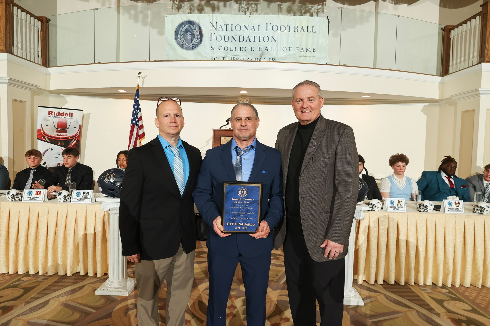 dave lagamba and mike gatley presenting an award to pat dioguardo