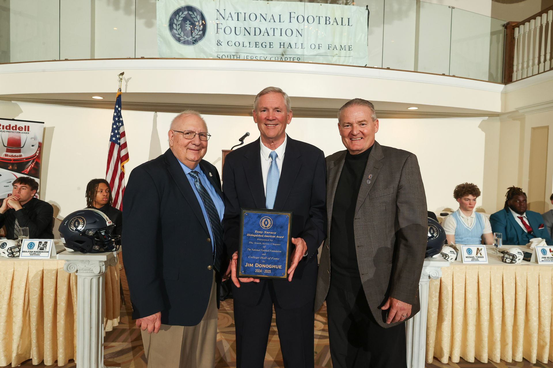 tony surace and mike gatley presenting an award to jim donoghue