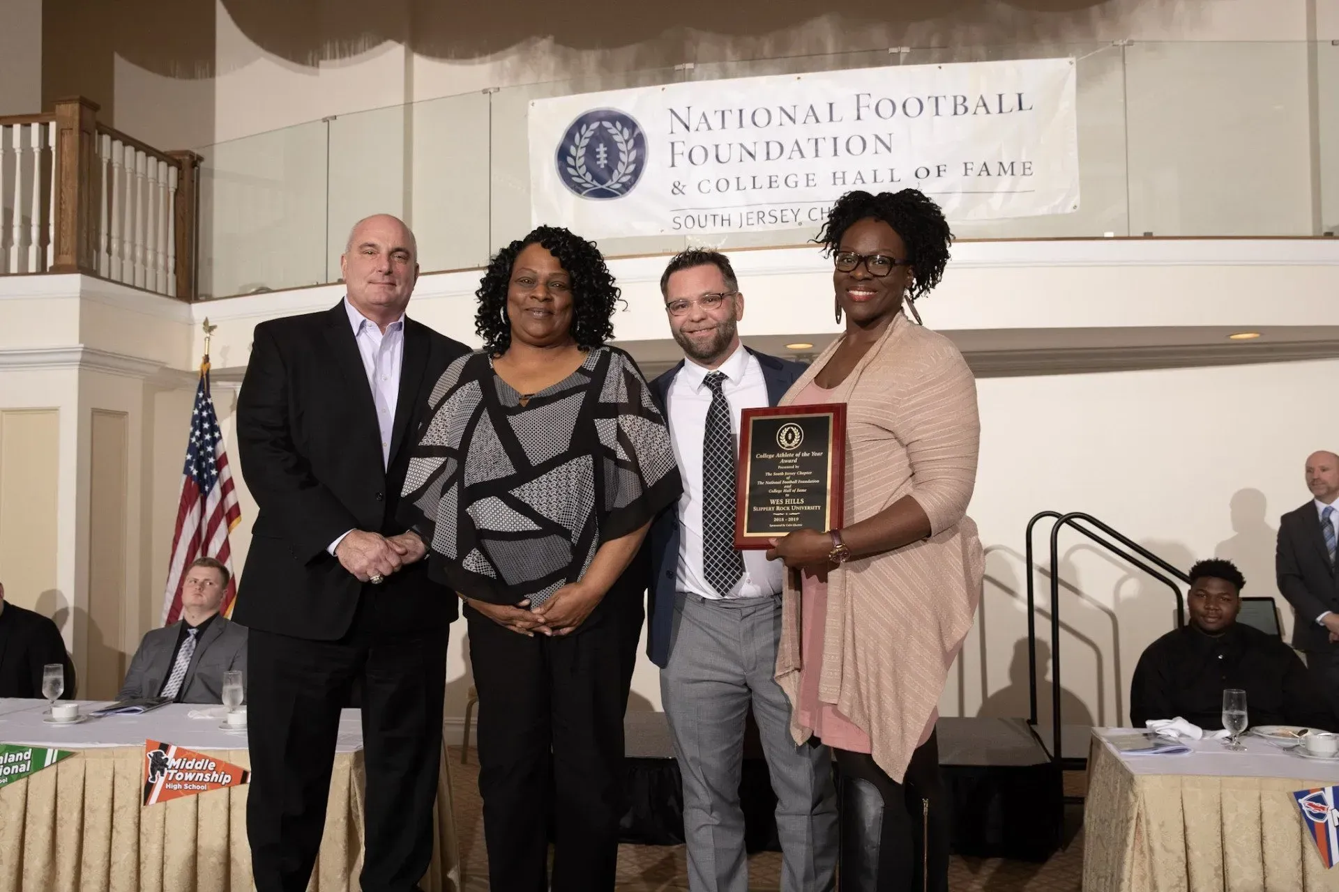 a group of people standing in front of a sign that says national foundation