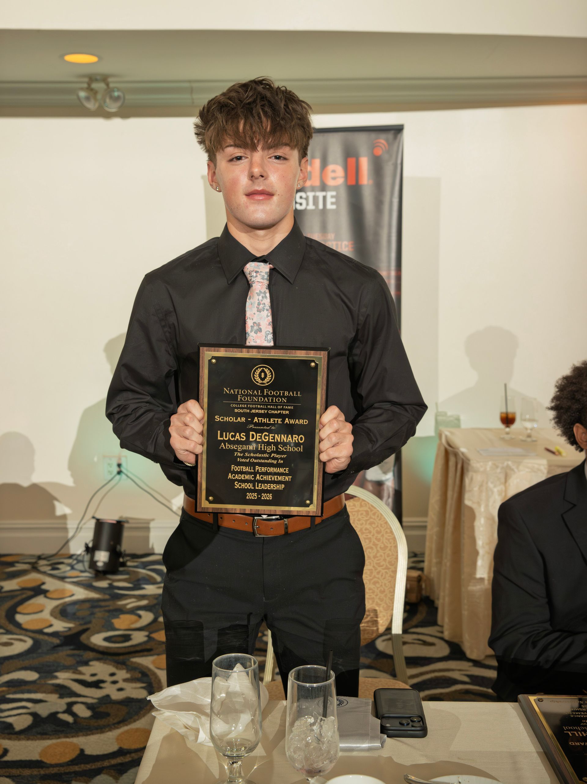 Lucas DeGemmaro from Absegami High School holding scholar-athlete awards plaque from NFFSJ