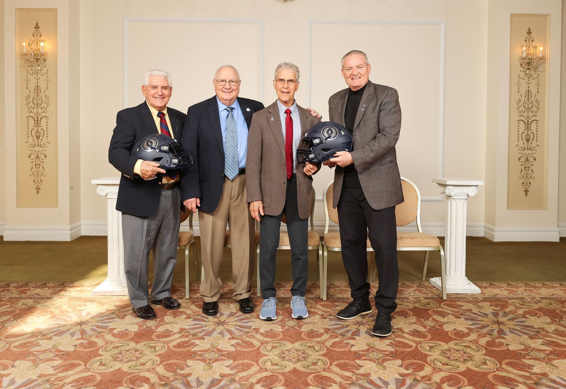 NFFSJ executive committee members holding football helmets