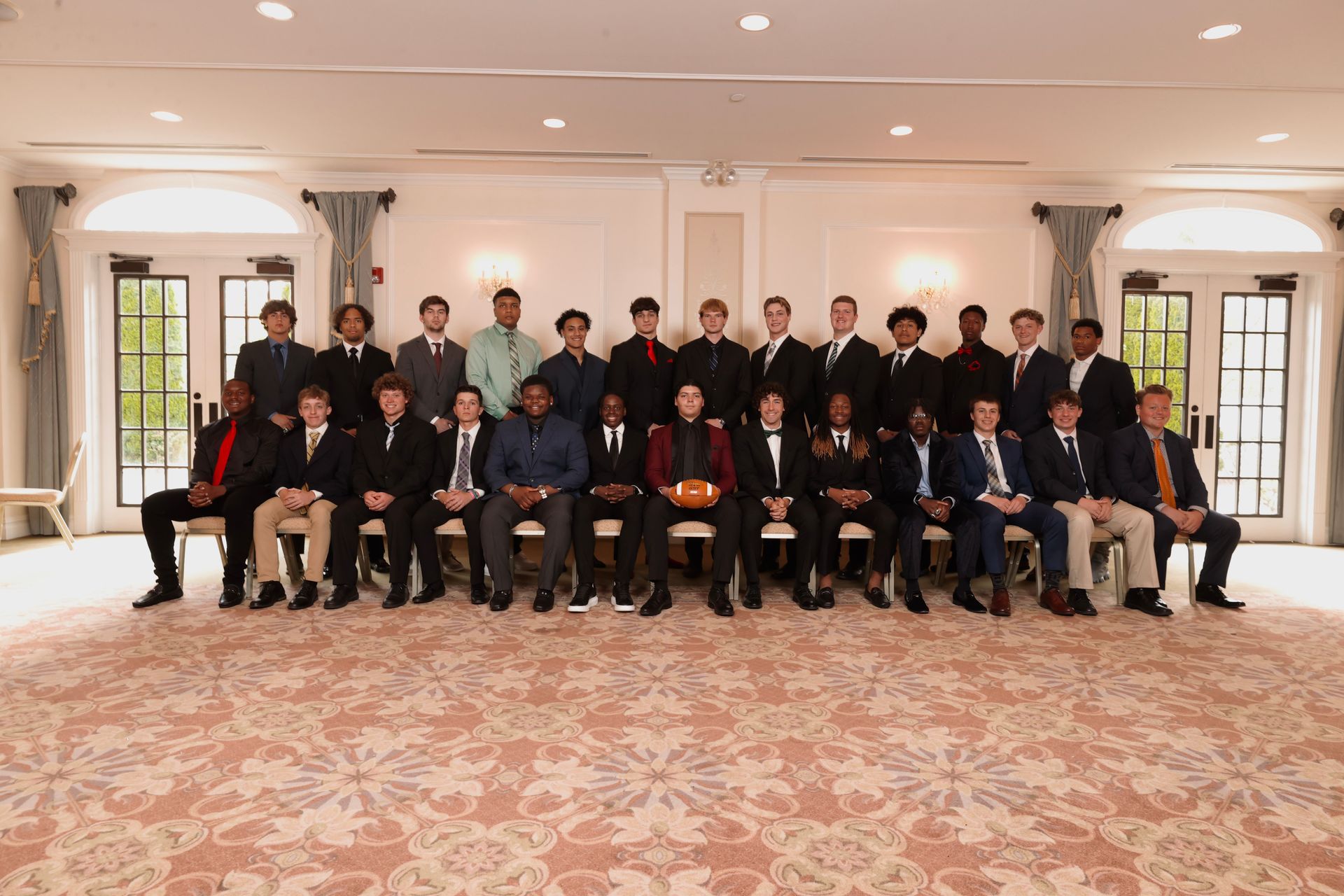 a group of men are posing for a picture in a room