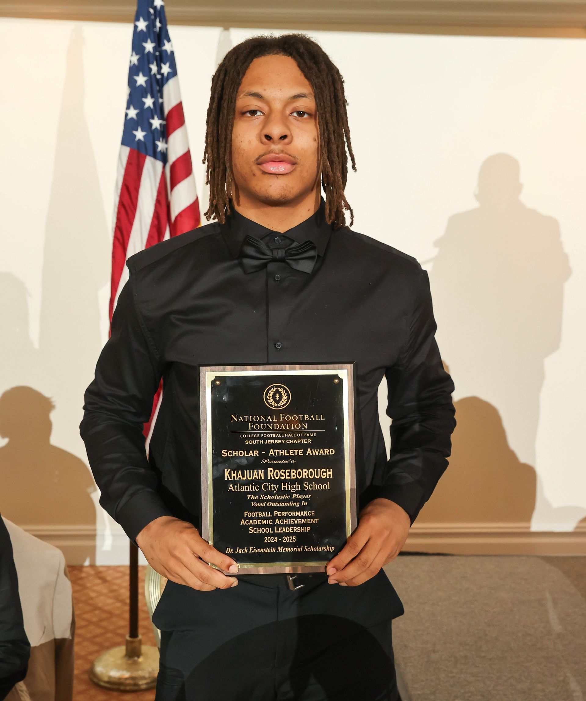 khajuan roseborough from atlantic city high school  holding an award plaque 