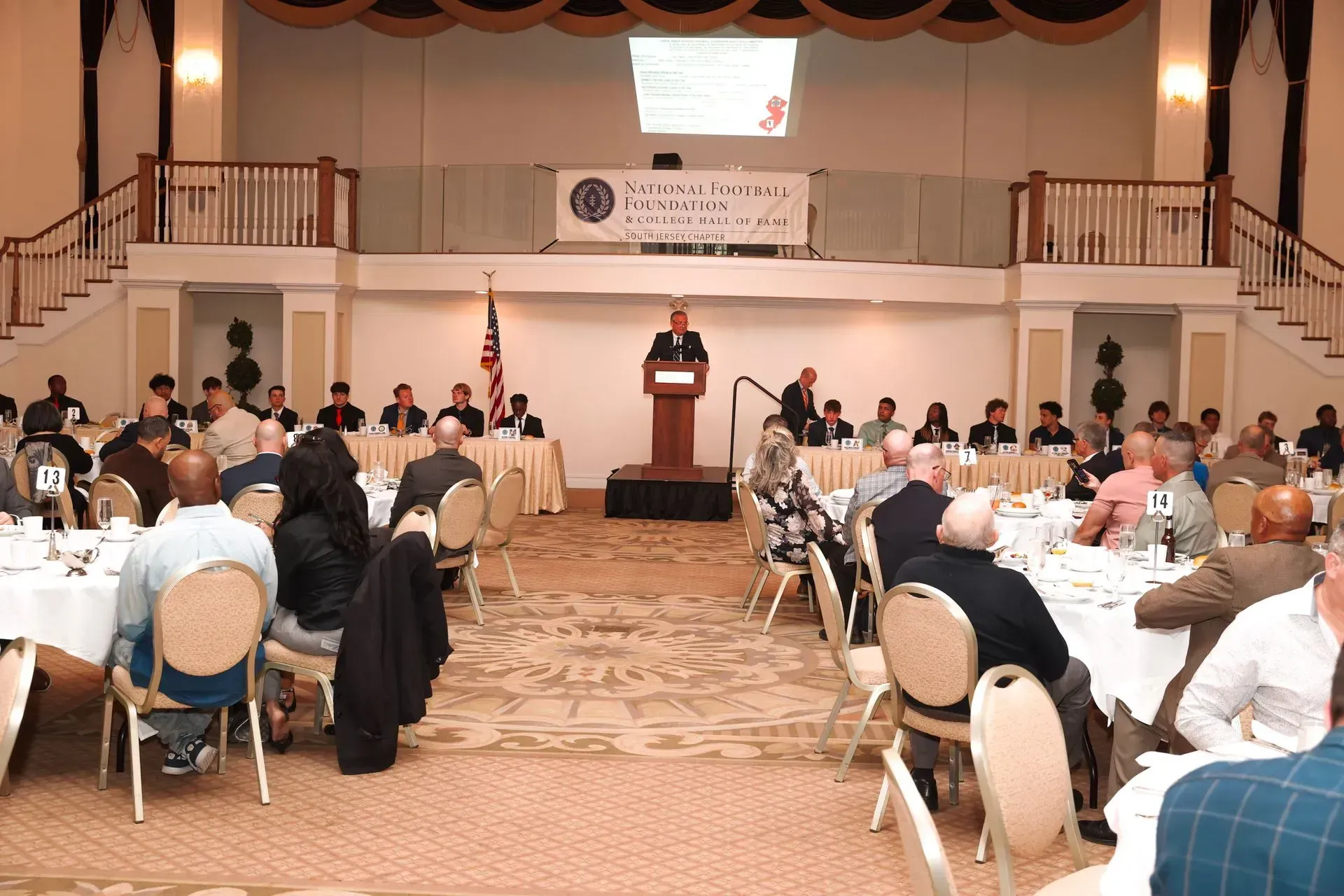 a man stands at a podium in front of a large group of people