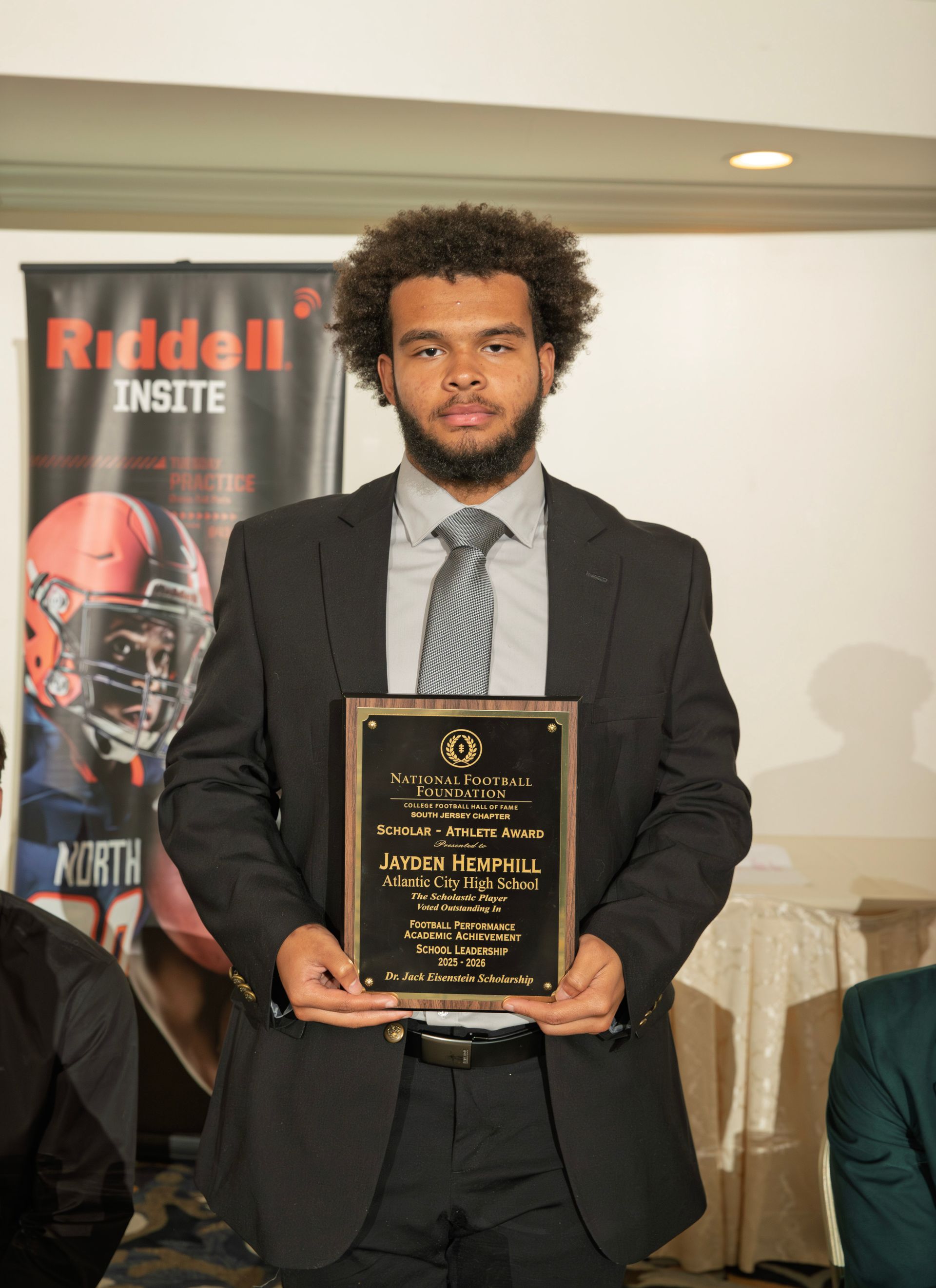 Jayden Hemphill from Atlantic City High School holding scholar-athlete awards plaque from NFFSJ