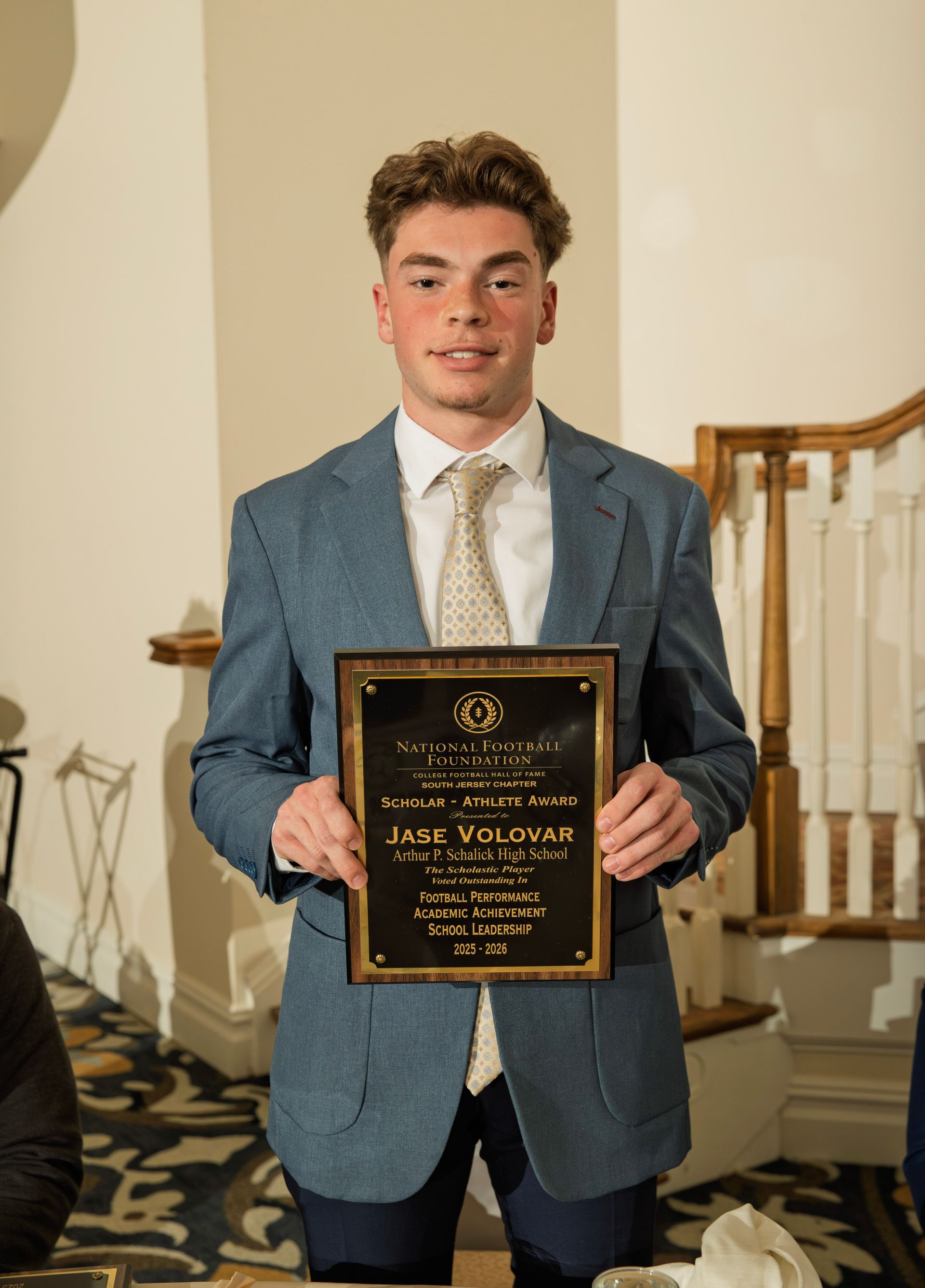 Jase Volovar from Arthur P. Schalick High School holding scholar-athlete awards plaque from NFFSJ