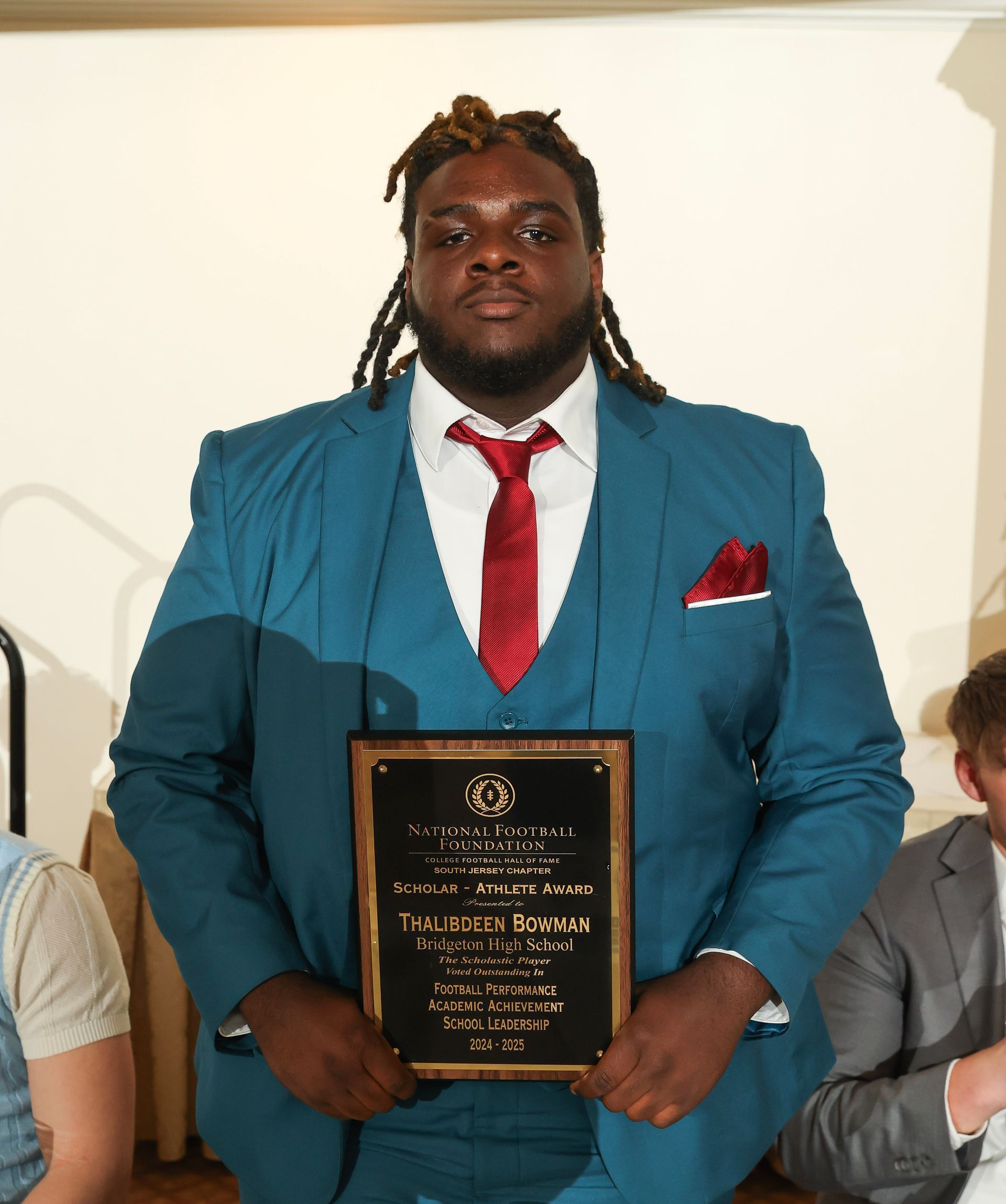 thalibdeen bowman of bridgeton high school holding an awards plaque