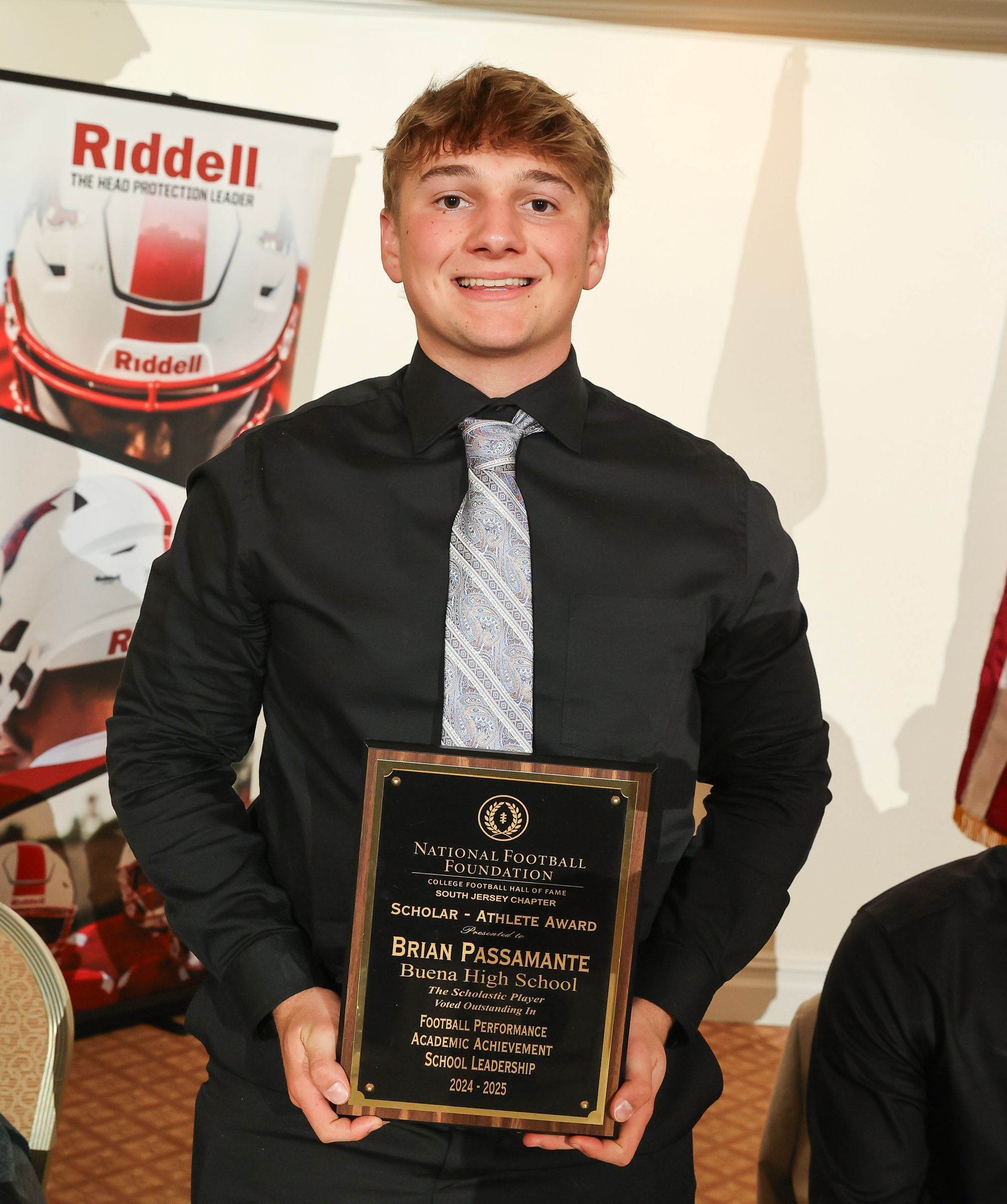 brian passamante of buena regional high school holding an awards plaque