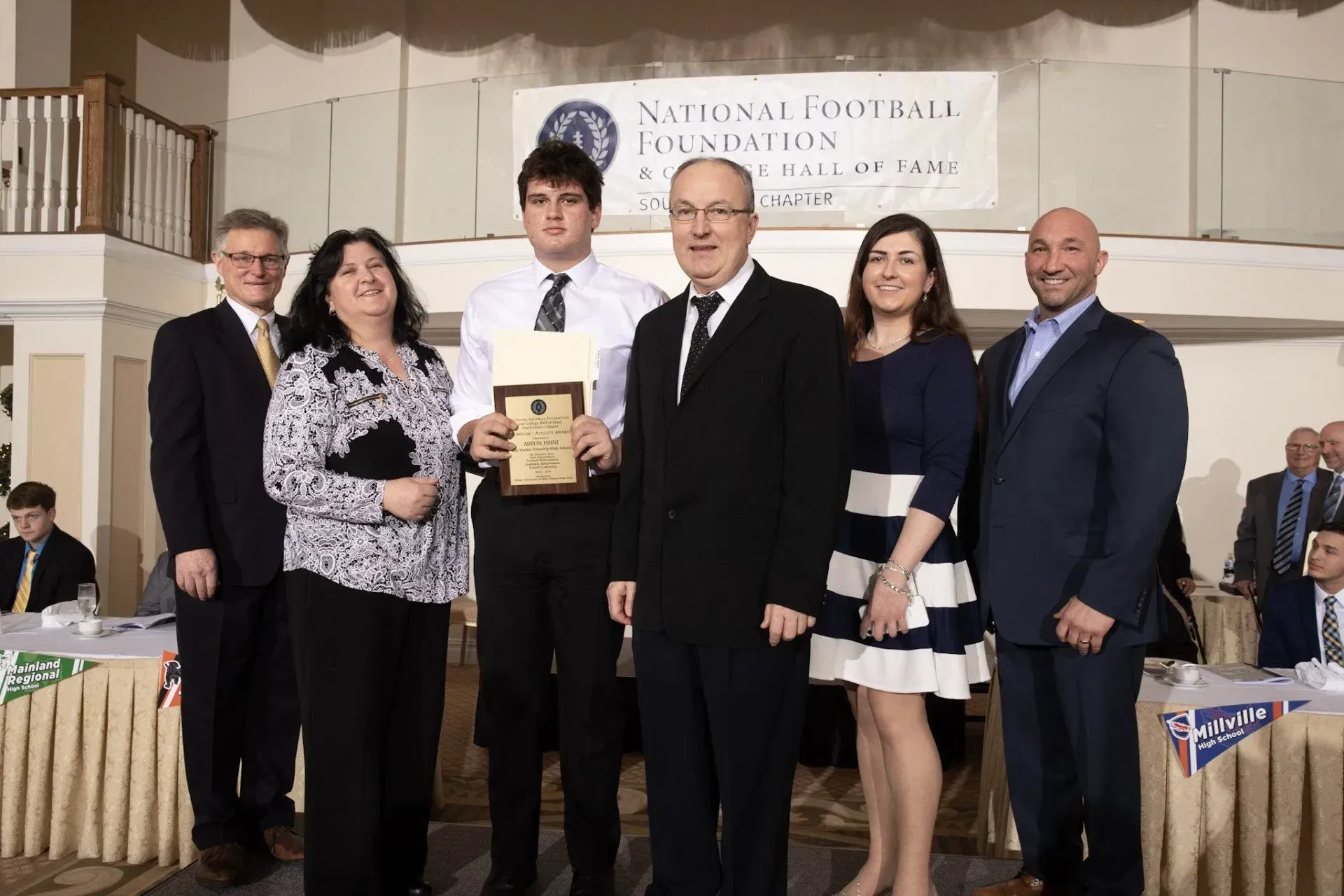 a group of people standing in front of a sign that says foundation