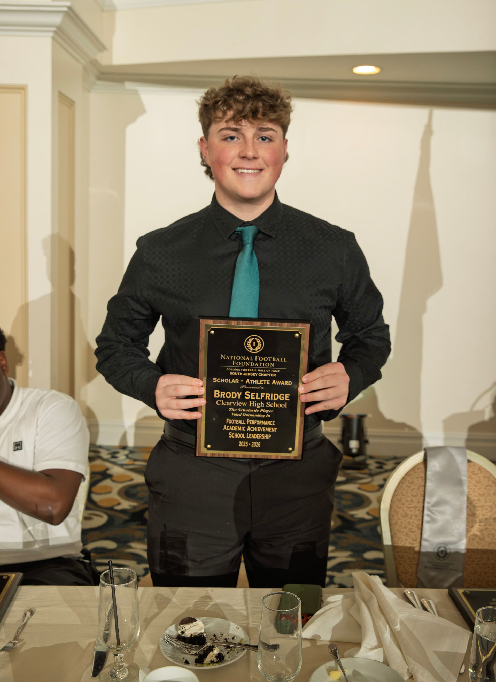 Brody Selfridge from Clearview Regional High School holding scholar-athlete awards plaque from NFFSJ