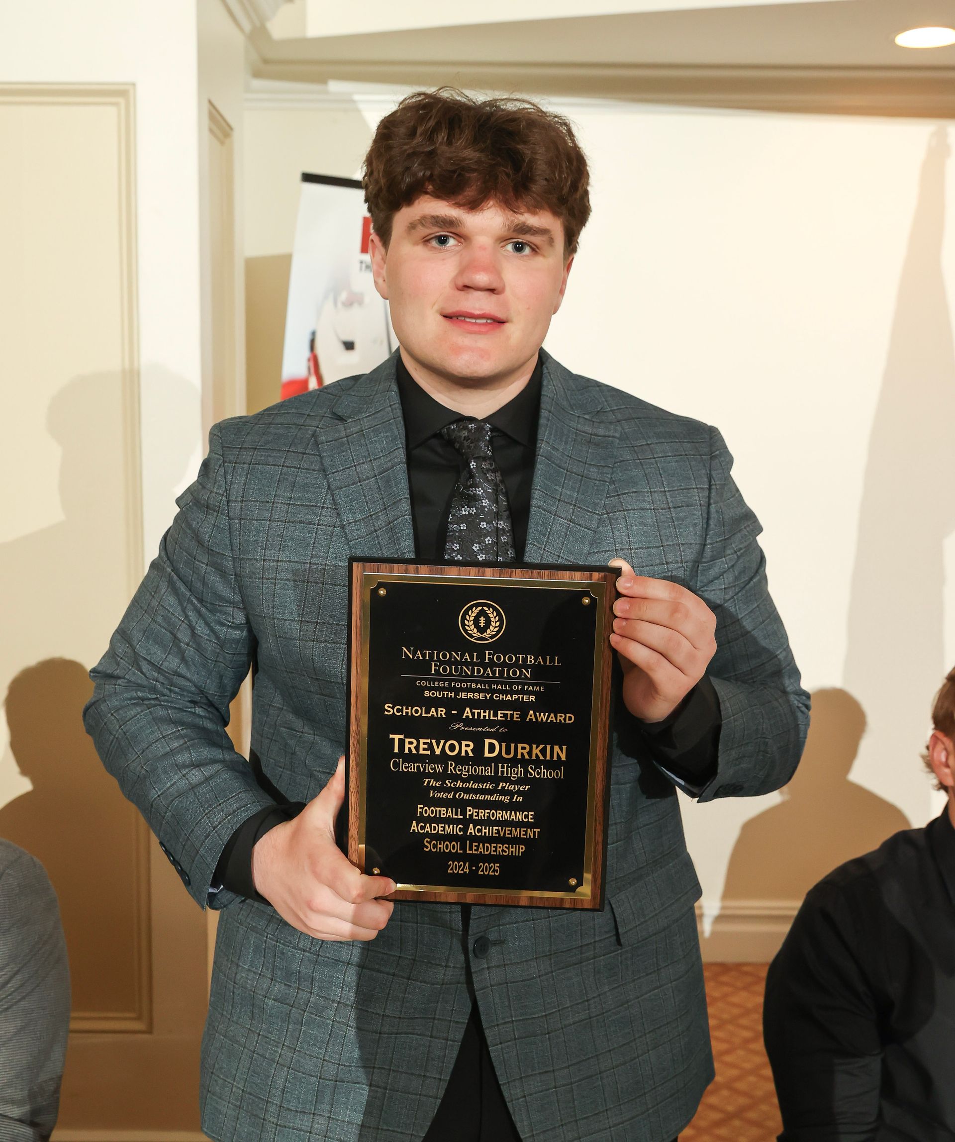 trevor durkin of clearview regional high school holding an awards plaque