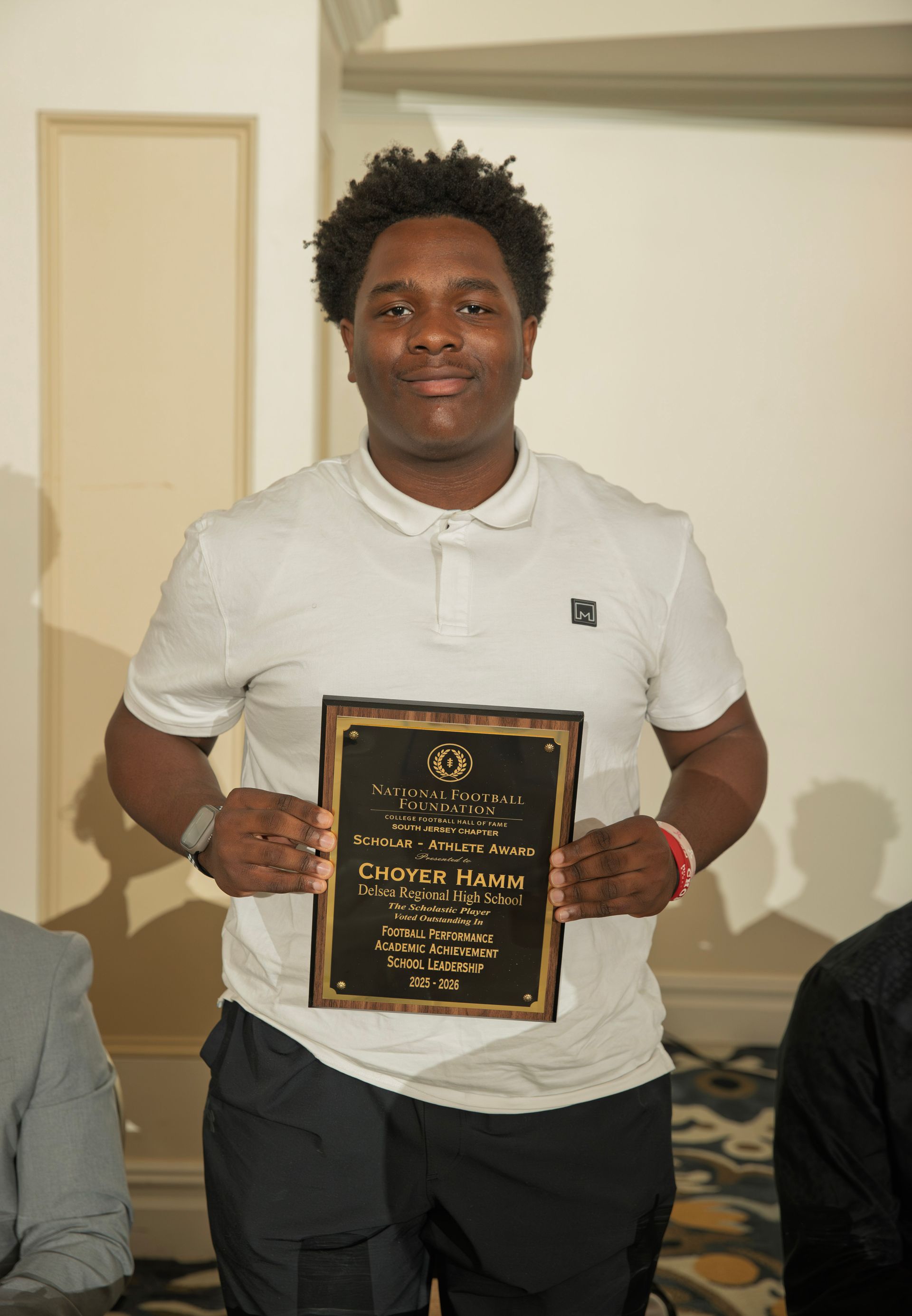 Choyer Hamm from Delsea Regional High School holding scholar-athlete awards plaque from NFFSJ