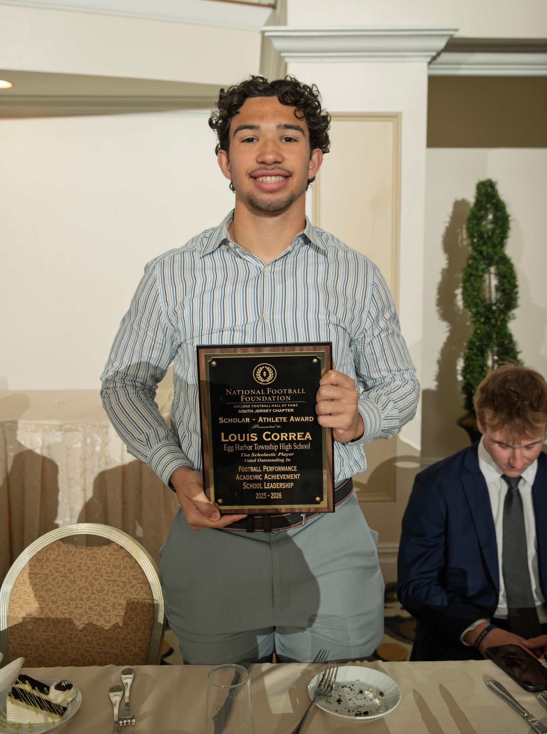 Louis Correa from Egg Harbor Township High School holding scholar-athlete awards plaque from NFFSJ