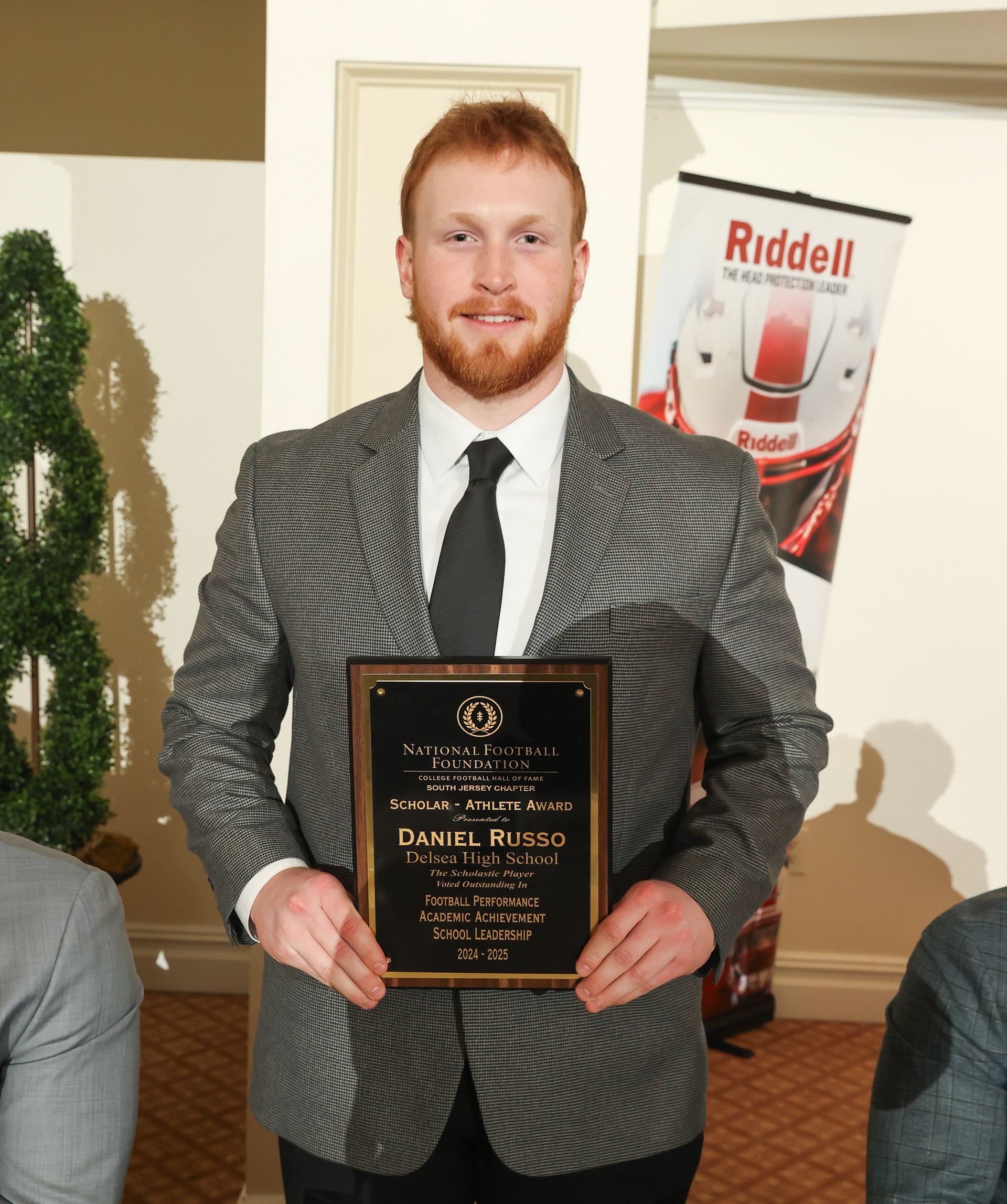 daniel russo of delsea regional high school holding an awards plaque