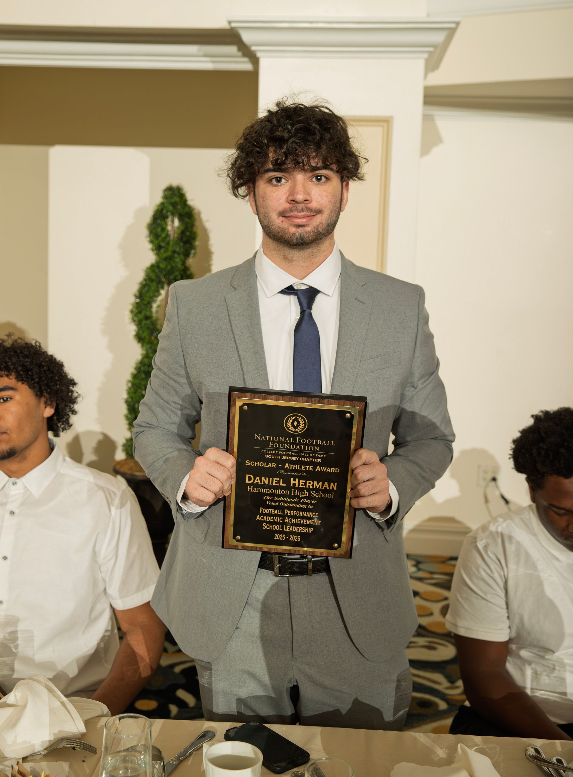 Daniel Herman from Hammonton High School holding scholar-athlete awards plaque from NFFSJ