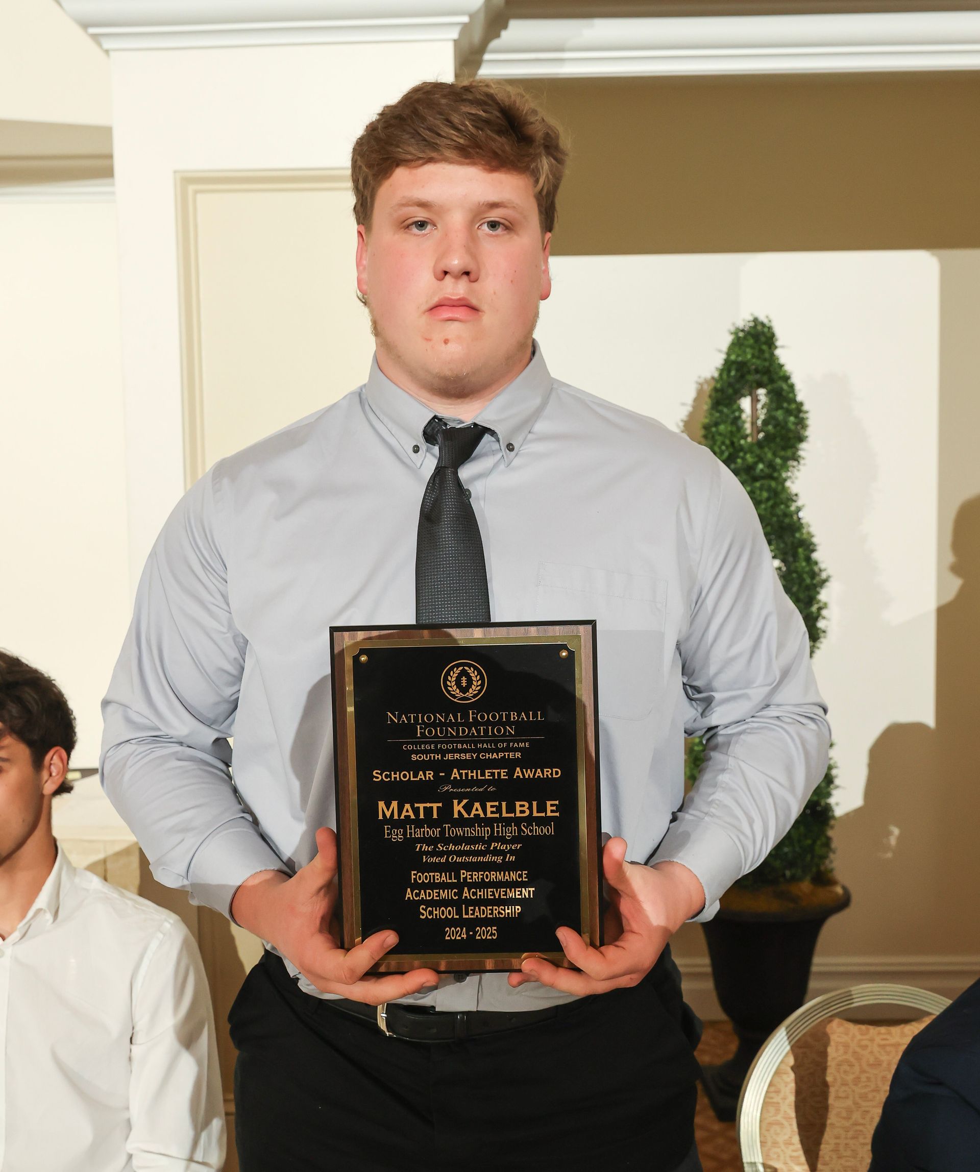 matt kaelble of egg harbor township high school holding an awards plaque