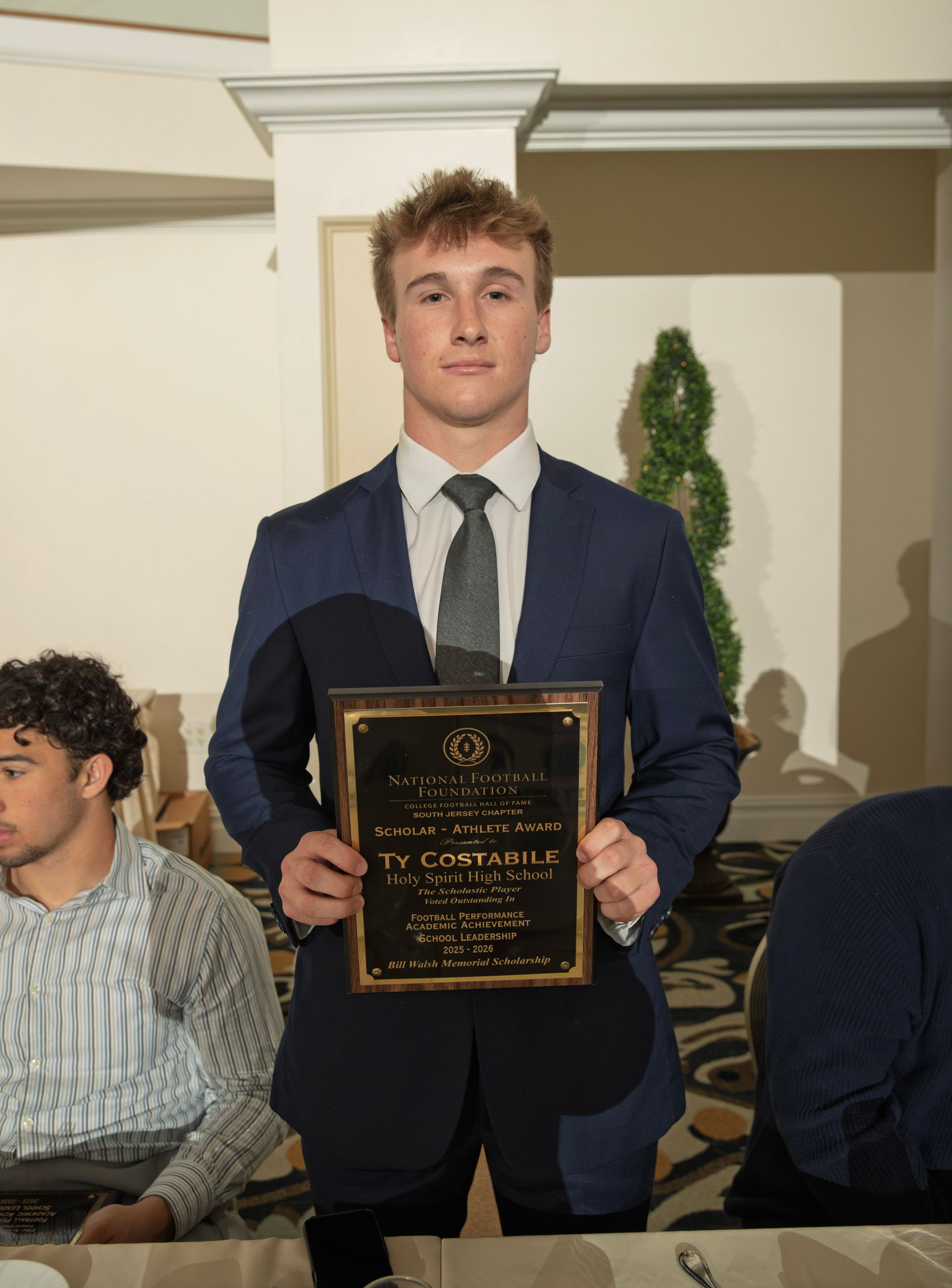 Ty Costabile from Holy Spirit High School holding scholar-athlete awards plaque from NFFSJ