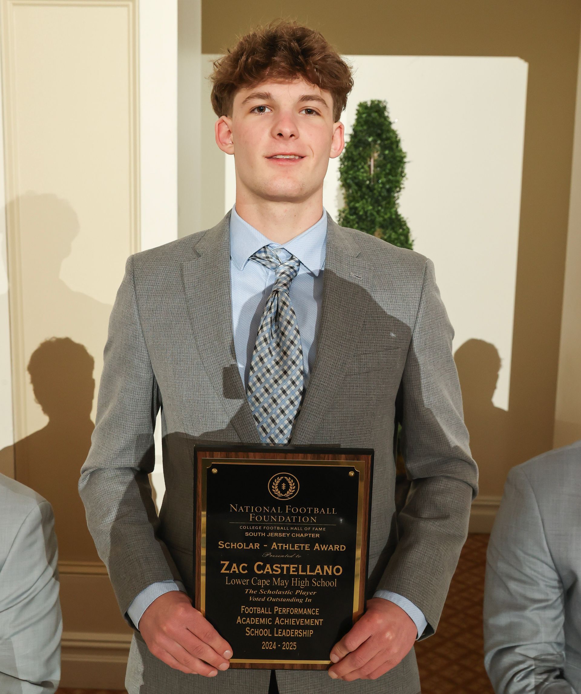 zac castello of lower cape may regional high school holding an awards plaque