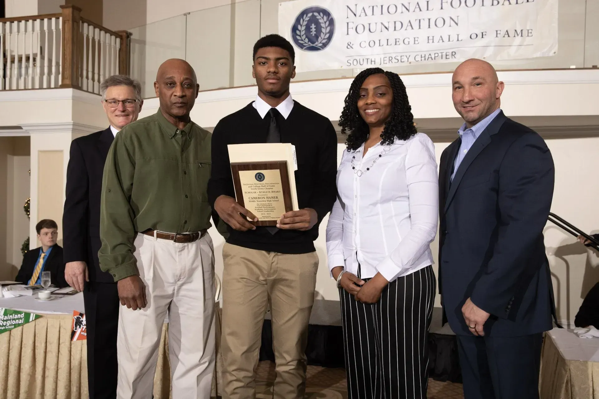 a group of people standing in front of a national foundation banner